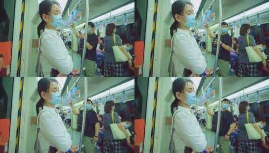 青年女人戴着口罩乘坐地铁高清在线视频素材下载