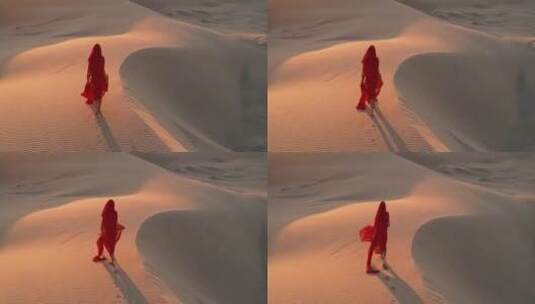 航拍沙漠中行走的红衣女子高清在线视频素材下载