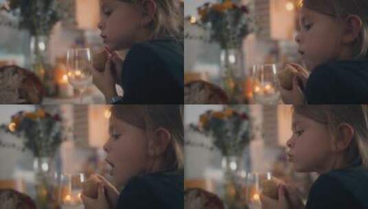 女孩儿在餐桌上吃面包卷高清在线视频素材下载