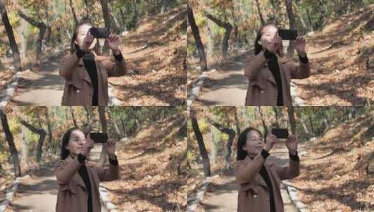 亚洲中国女性树林旅游漫步拍照对话看风景高清在线视频素材下载