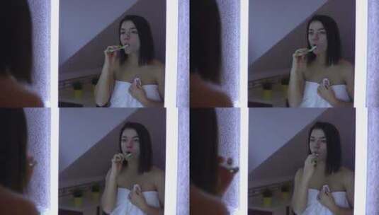 女人在卫生间对着镜子刷牙高清在线视频素材下载