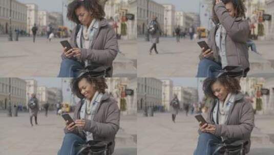 女孩坐在城市街道的长椅上高清在线视频素材下载