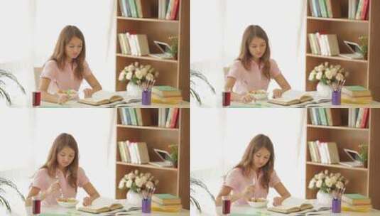 女孩边学习边吃沙拉高清在线视频素材下载