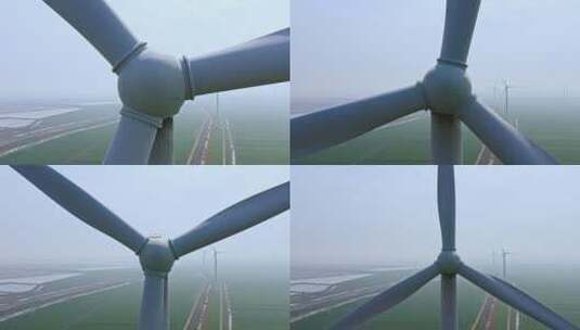 航拍高视角田地间的风力发电涡轮机特写高清在线视频素材下载