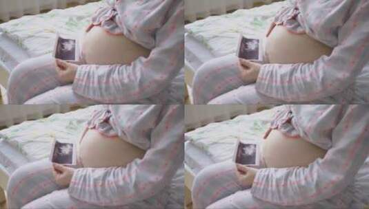 孕妇抚摸肚子看婴儿超声波照片高清在线视频素材下载