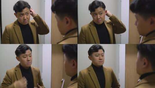 穿着西装的年轻亚洲男子在镜子前整理头发和夹克高清在线视频素材下载