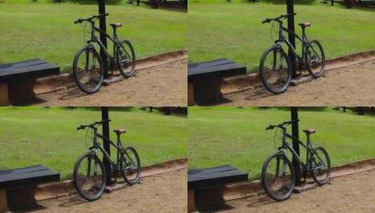 停在公园草地边上的自行车高清在线视频素材下载