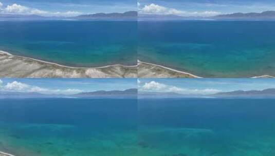 航拍晴天新疆赛里木湖清澈的蓝绿色渐变湖水高清在线视频素材下载