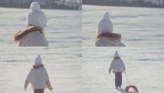 女孩微笑着拉着雪橇走在雪地里高清在线视频素材下载