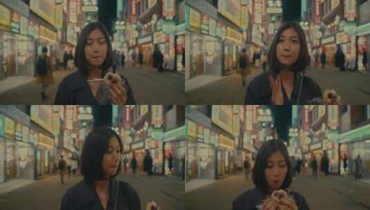 女人在街头吃着小吃散步高清在线视频素材下载