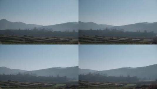 乡村视频云南山区烟雾下隐藏村庄全景高清在线视频素材下载