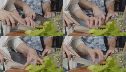 厨房里切菜的夫妇特写镜头高清在线视频素材下载