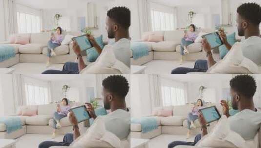 夫妇坐在客厅里使用平板电脑高清在线视频素材下载