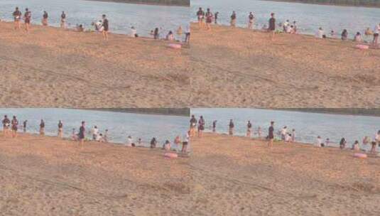 落日余晖河边沙滩游玩的人6高清在线视频素材下载