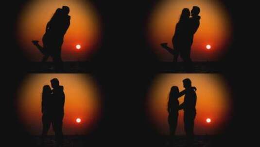 一对夫妇在夕阳下拥抱的剪影高清在线视频素材下载