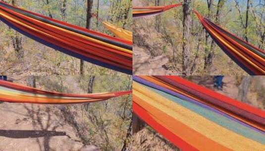户外登山爱好者，在林间彩虹一样的吊床小憩高清在线视频素材下载
