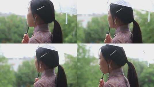下雨场景，旗袍女孩打伞撑在雨中，雨滴落下高清在线视频素材下载