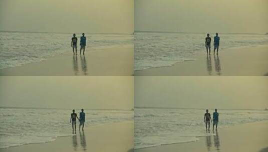 站在海滩上放松的非洲男孩剪影高清在线视频素材下载