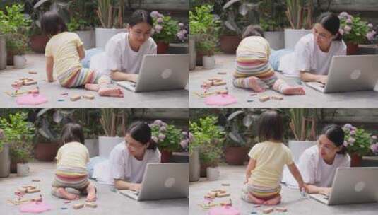 小女孩和妈妈在一起玩耍母亲工作中带娃高清在线视频素材下载