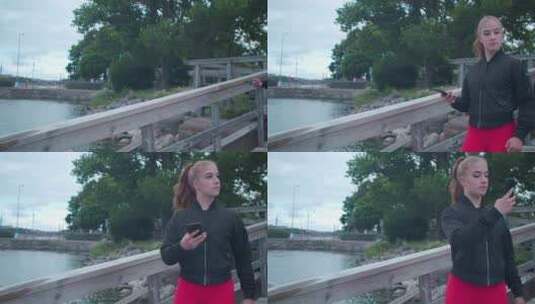女孩走在木桥上用手机拍照高清在线视频素材下载