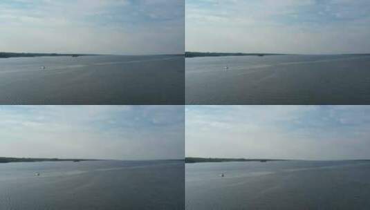阳光明媚的一天，无人驾驶飞机看到湖中的一艘船高清在线视频素材下载