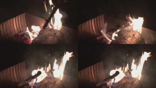夜间巨型盒子火坑中大型原木燃烧的手持镜头高清在线视频素材下载