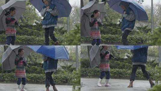 女孩和男孩拿着雨伞在雨中跳上跳下高清在线视频素材下载