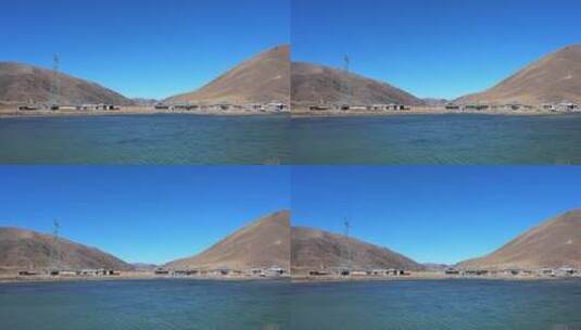 高原上古老的藏族村庄与蓝色湖泊高清在线视频素材下载