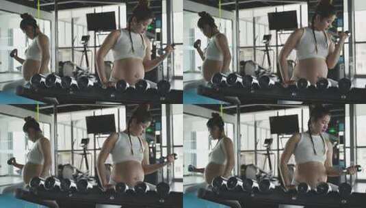 怀孕的妇女在健身房锻炼身体撸铁举哑铃高清在线视频素材下载
