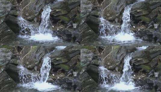 4K山泉水顺着石头流下升格视频高清在线视频素材下载