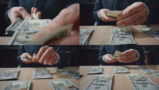 银行家手在木桌特写镜头前堆积如山地收集美元。不知名的商人在办公室数纸币。会计师把一百张钞票堆在一起。金钱概念高清在线视频素材下载