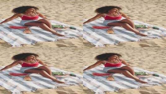 女人在海滩上晒太阳的竖屏视频高清在线视频素材下载