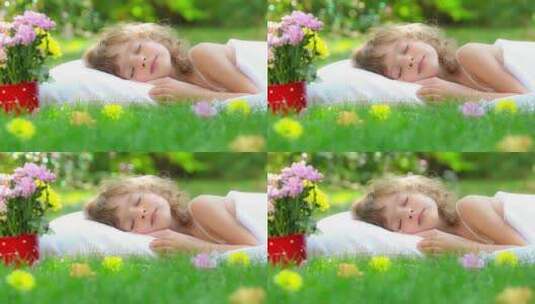 可爱的小女孩，草地上睡觉，做梦高清在线视频素材下载