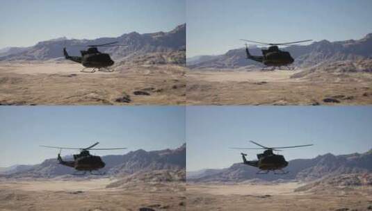 一架直升机飞过背景是山脉的沙漠景观高清在线视频素材下载