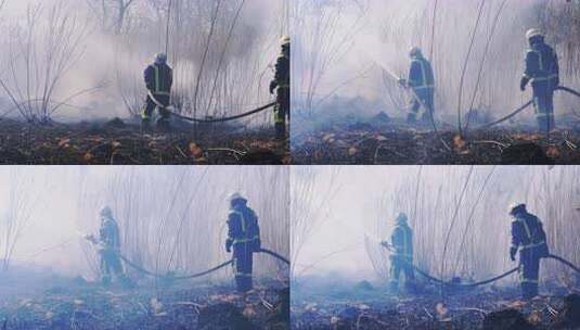 两名装备消防员用消防水带扑灭森林大火。慢高清在线视频素材下载