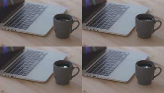 黑咖啡饮料旁边的银色平板电脑高清在线视频素材下载