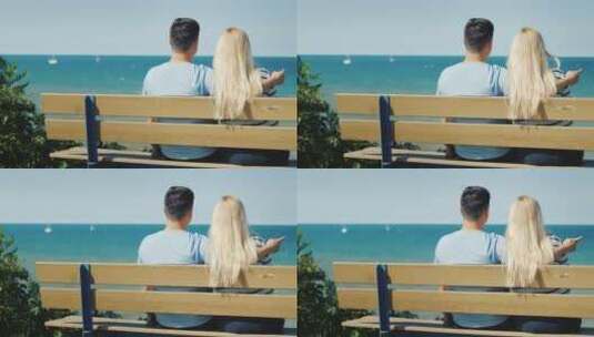 情侣坐在海岸的长椅上休息高清在线视频素材下载