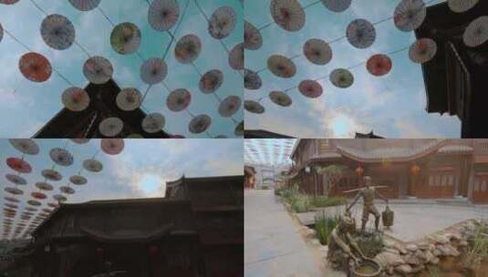云南普洱茶马古城花纸伞和铜雕像高清在线视频素材下载