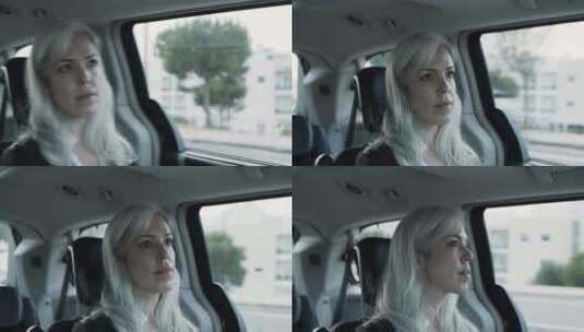 坐在汽车后座的银发女人到处张望高清在线视频素材下载