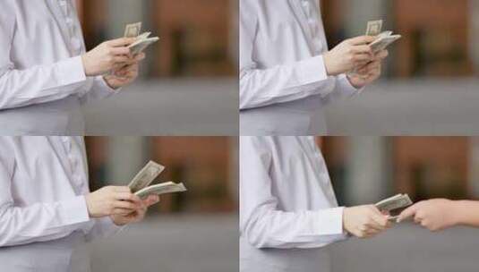 女人在数钱给对方之后握手达成交易高清在线视频素材下载