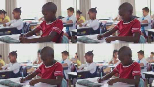 非裔美国学生坐在教室里做笔记的肖像高清在线视频素材下载