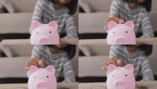 在猪猪储蓄管理放入钱币进行存钱高清在线视频素材下载