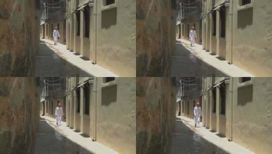 穆斯林男子走在狭窄的小巷里高清在线视频素材下载