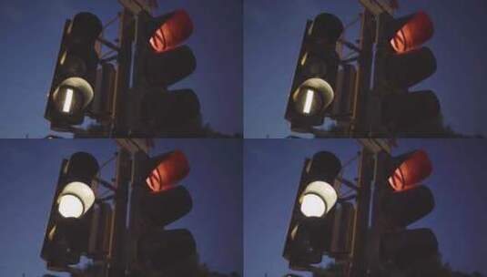 黄昏时的红绿灯，发出发光的红色信号和一盏高清在线视频素材下载