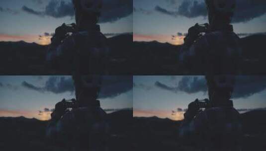 戴头盔的男人拍日落照片高清在线视频素材下载