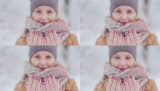 女人用双手接住漫天飘落的雪花高清在线视频素材下载