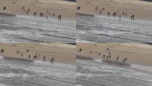 航拍俯瞰威海金海湾海水浴场的沙滩海浪高清在线视频素材下载