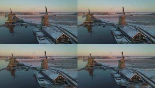 Zaanse Schans风车村的木制风力磨坊在冬季与雪景雪高清在线视频素材下载