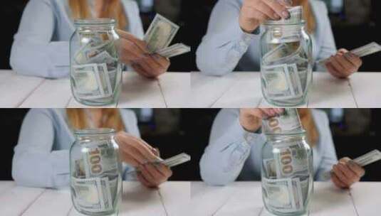女人手的特写镜头把我们的美元钱放进玻璃梅森罐子里高清在线视频素材下载