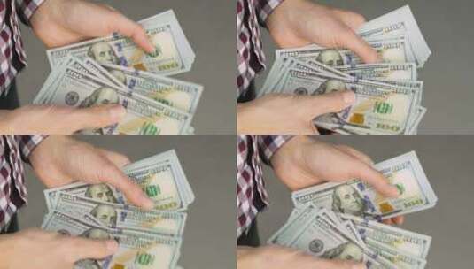 数着一叠一百美元钞票的男性手的特写镜头高清在线视频素材下载